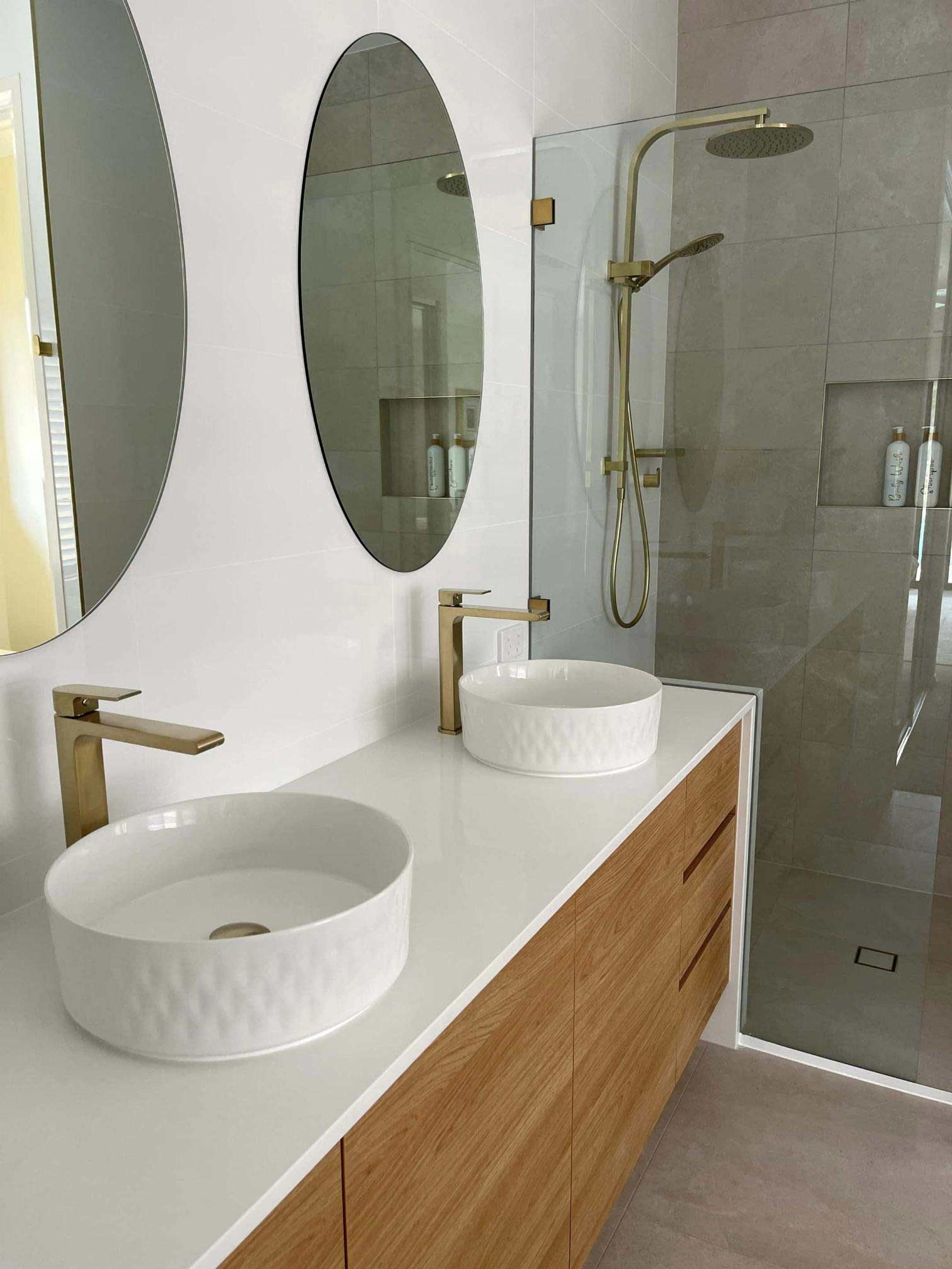 A Bathroom With Two Sinks, Two Round Mirrors — Nyblad Construction in Caloundra West, QLD