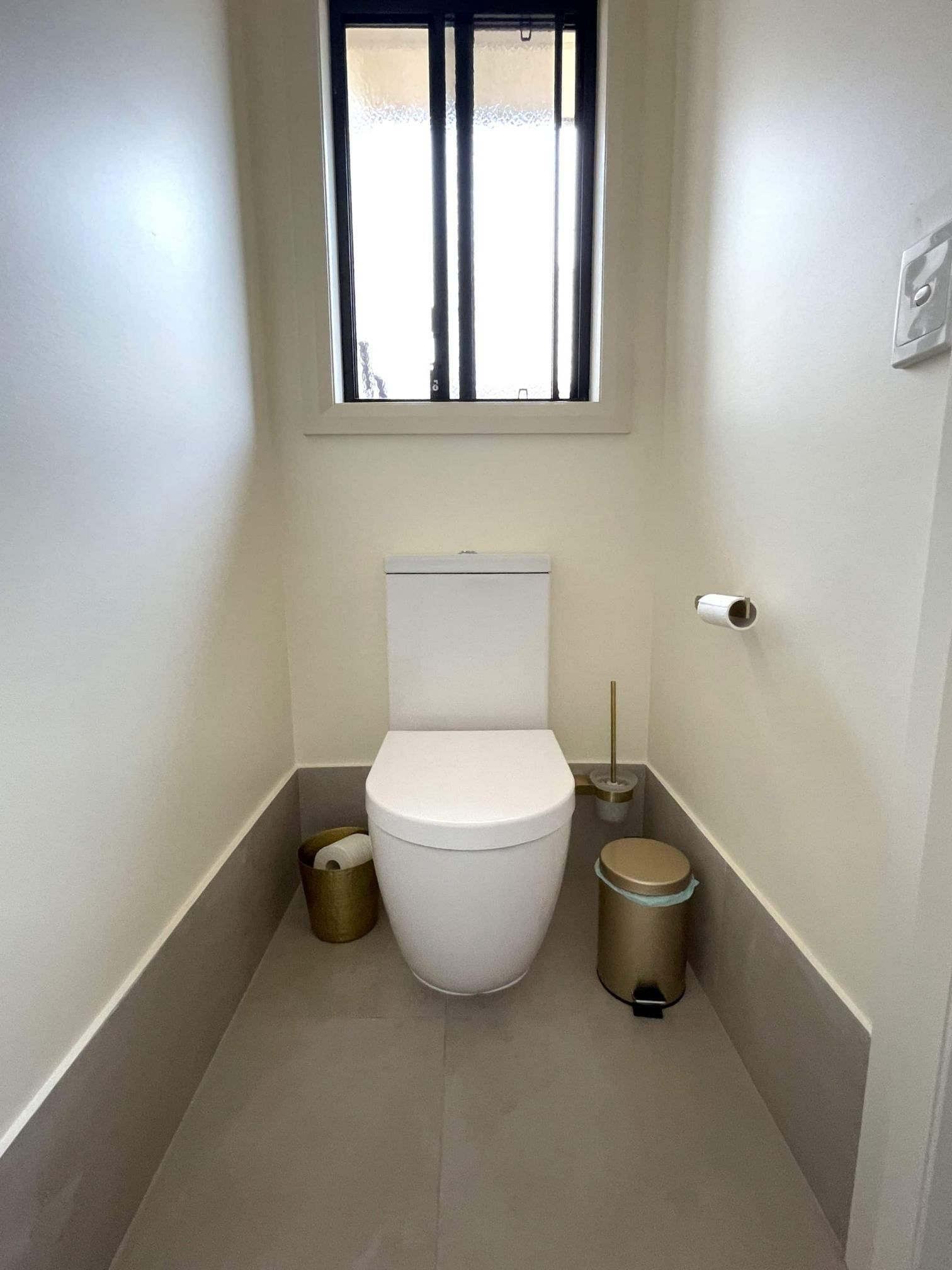 A Toilet Is Sitting In A Small Bathroom Next To A Window — Nyblad Construction in Caloundra West, QLD