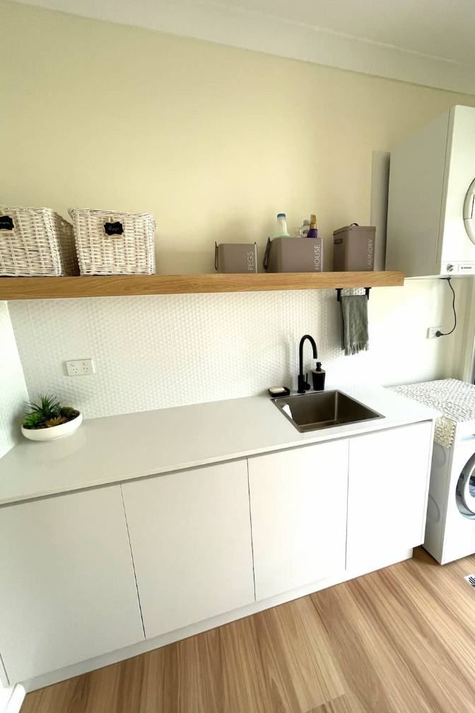 A Laundry Room With A Sink, Washer And Dryer — Nyblad Construction in Caloundra West, QLD