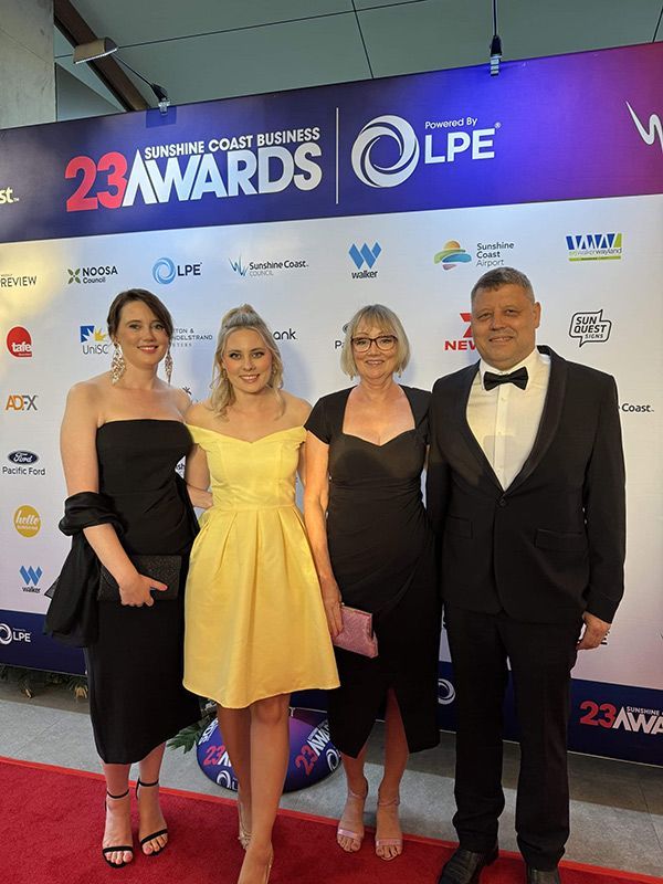 Standing On A Red Carpet In Front Of A Wall That Says 23 Awards — Nyblad Construction in Caloundra West, QLD