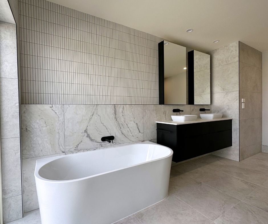 Modern Bathroom With White Tub, Floating Black Vanity — Nyblad Construction in Caloundra West, QLD