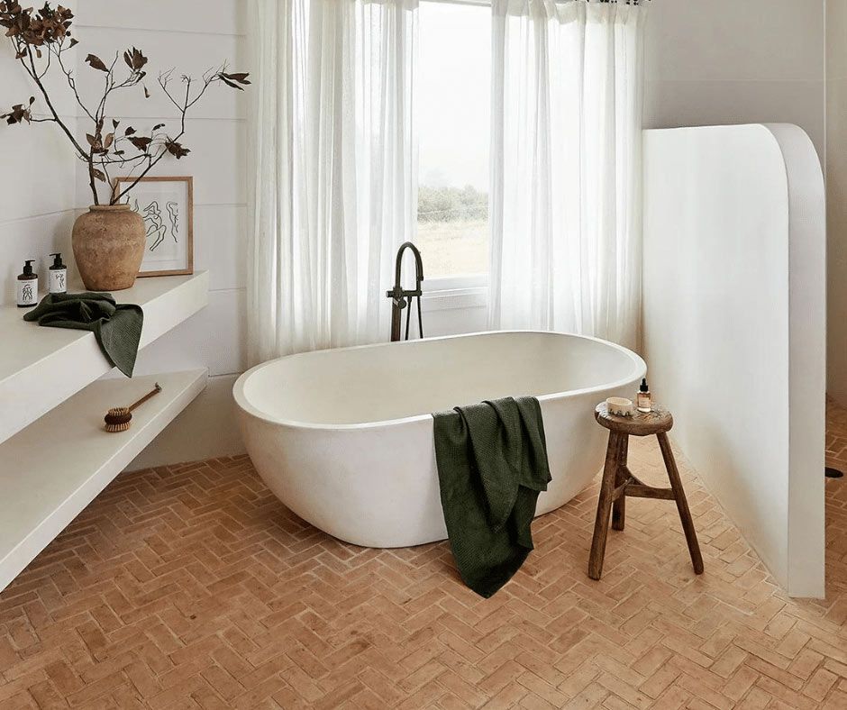 Bathtub With Green Towel And Stool — Nyblad Construction in Caloundra West, QLD
