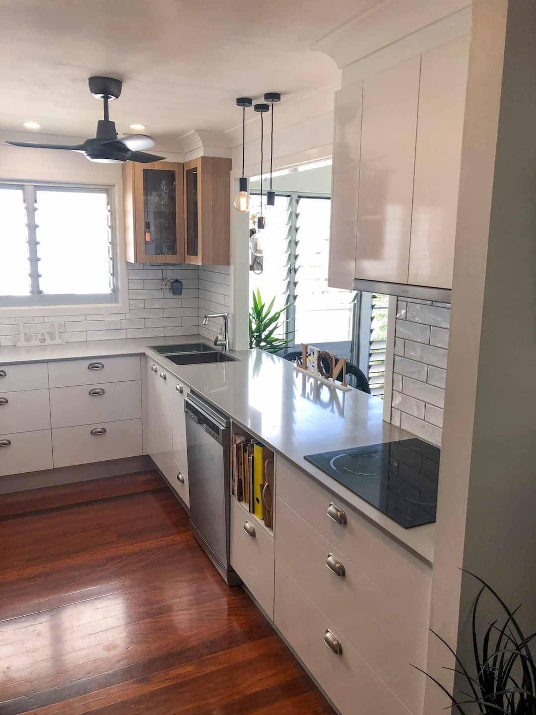 Kitchen With White Cabinets and Wooden Floors — Nyblad Construction in Caloundra West, QLD