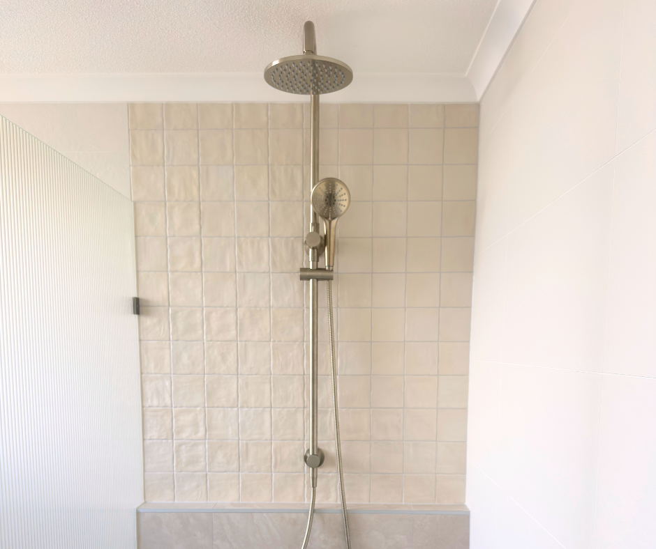 Shower Stall With Beige Tile, Silver Fixtures, and a Rain Shower Head — Nyblad Construction in Caloundra West, QLD