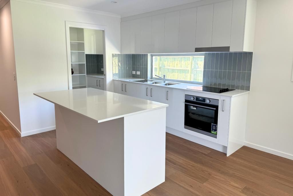 Kitchen With White Cabinets and a Large Island — Nyblad Construction in Caloundra West, QLD