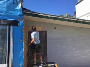  Man Stands On A Ladder Outside A House — Nyblad Construction in Caloundra West, QLD
