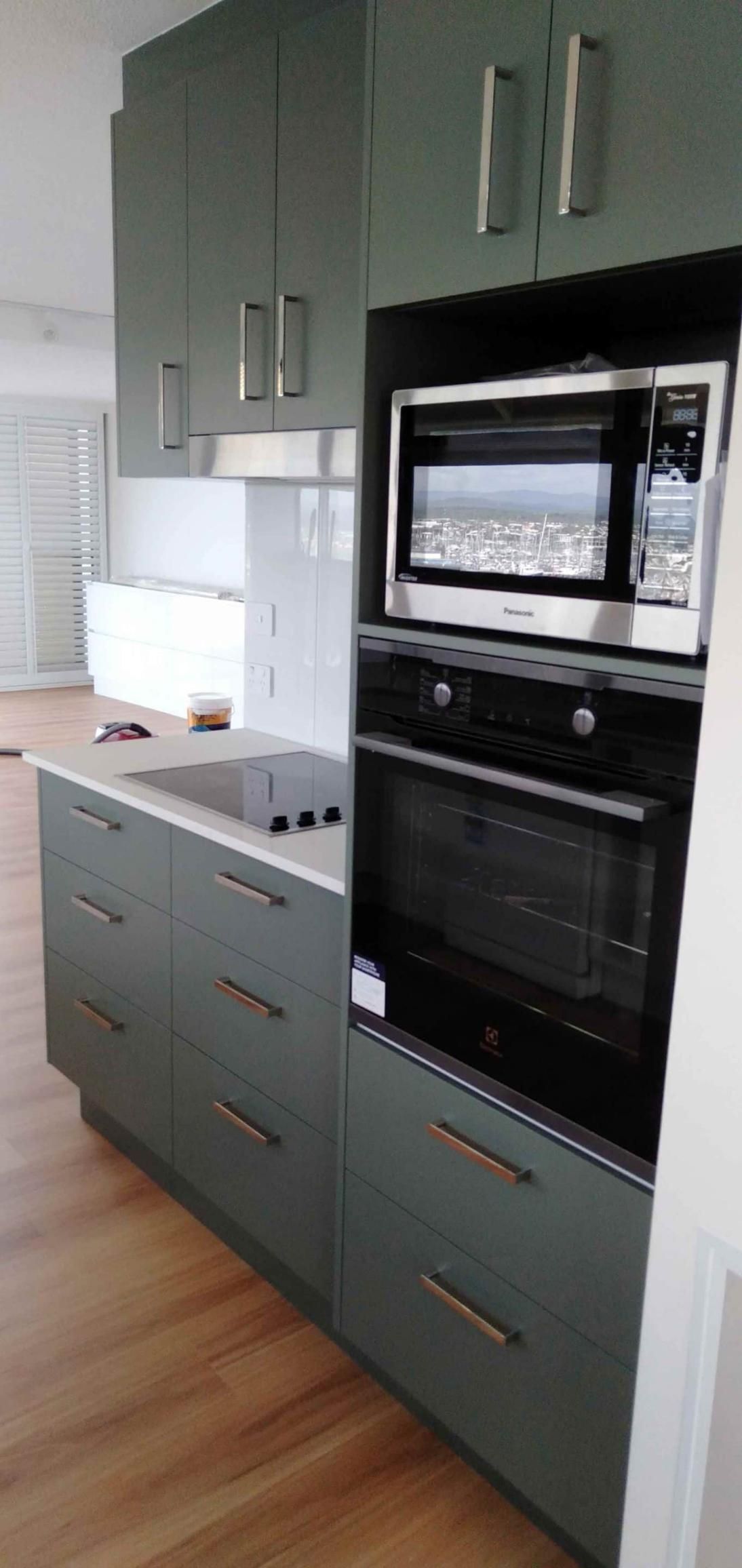 Kitchen With Green Cabinets — Nyblad Construction in Caloundra West, QLD