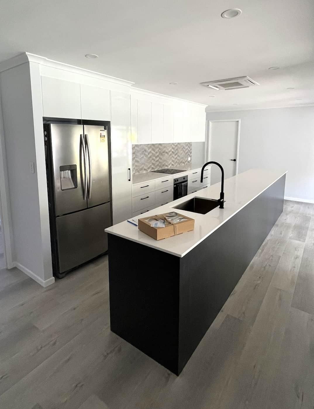 Kitchen With a Large Island and a Refrigerator — Nyblad Construction in Caloundra West, QLD