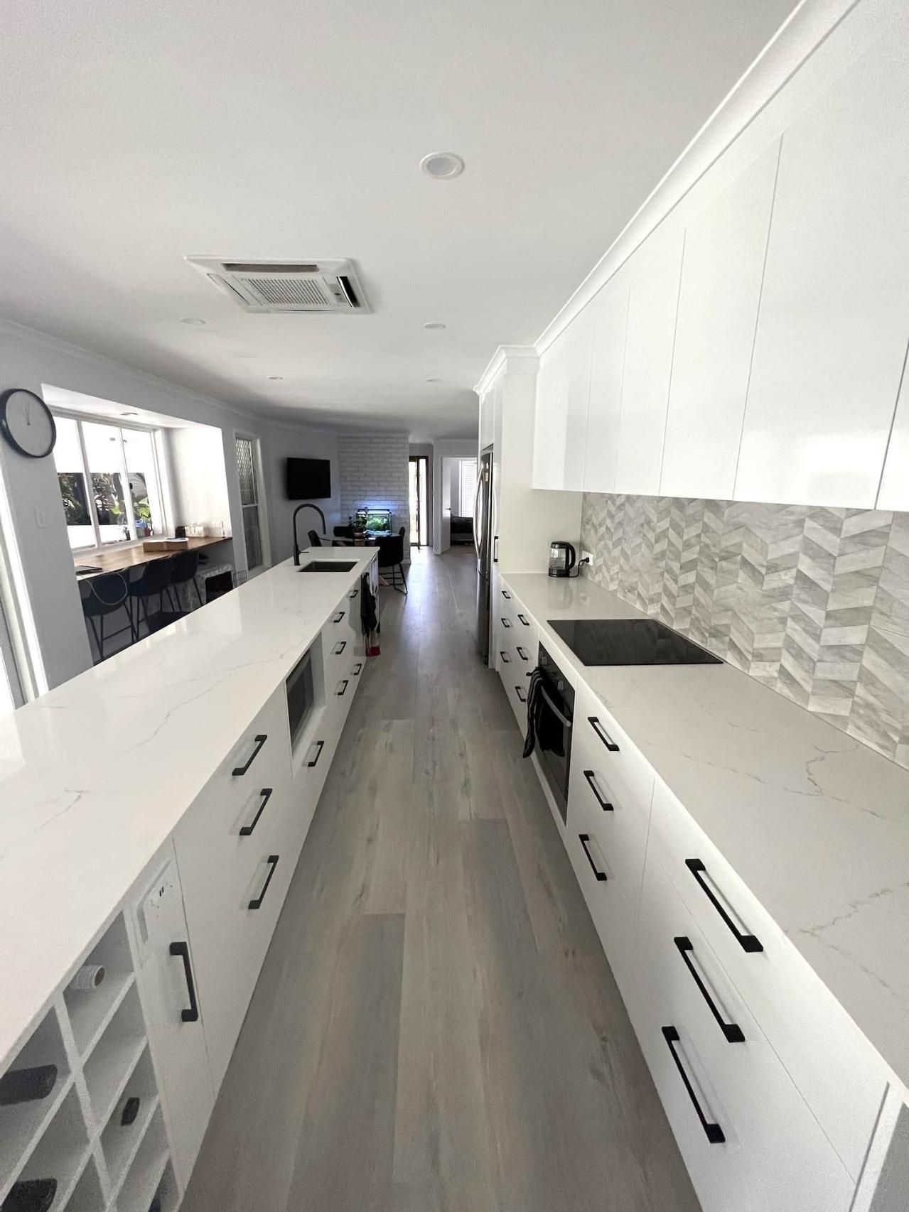 Long Kitchen With White Cabinets — Nyblad Construction in Caloundra West, QLD