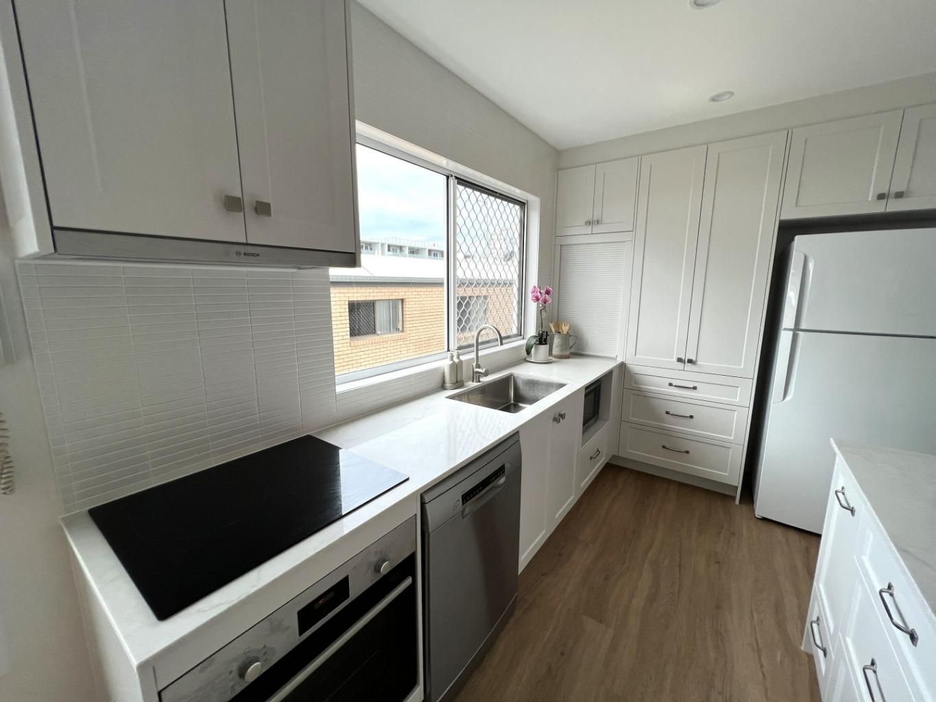 Kitchen With White Cabinets and Stainless Appliances — Nyblad Construction in Caloundra West, QLD