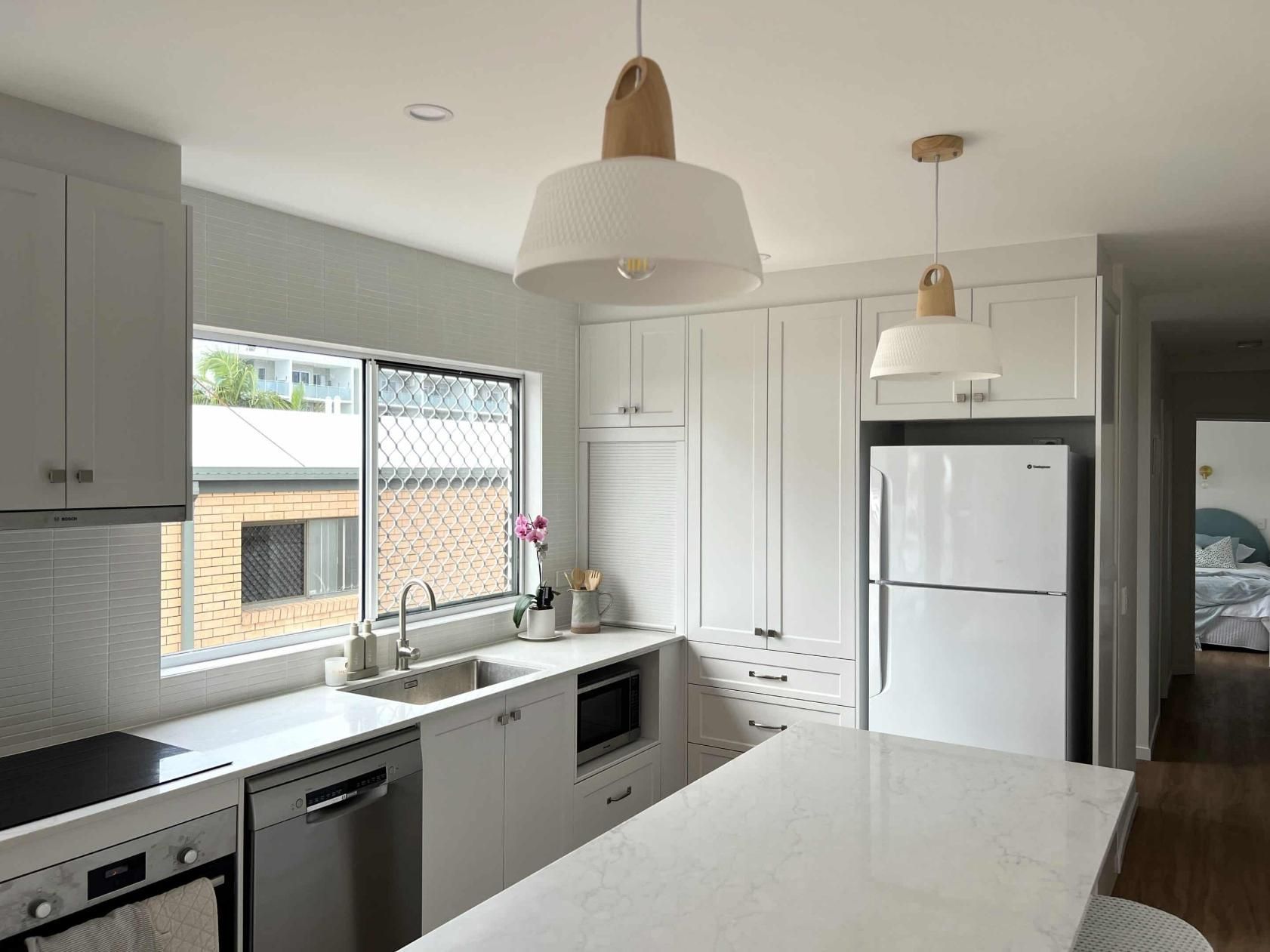 Kitchen With White Cabinets and a White Refrigerator — Nyblad Construction in Caloundra West, QLD