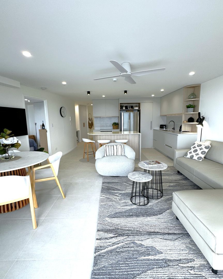 Bright, modern living space. Open floor plan with kitchen, living area, and dining, white and neutral tones. — Nyblad Construction in Coolum, QLD