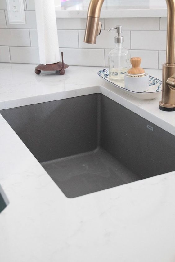 A Kitchen Sink With A Faucet And A Paper Towel Holder On The Counter — Nyblad Construction in Caloundra West, QLD