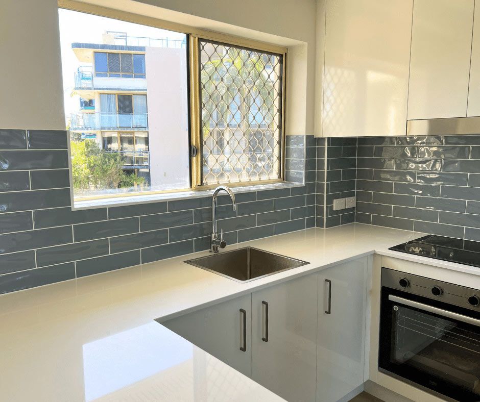Kitchen With Green Tiles Wall — Nyblad Construction in Caloundra West, QLD
