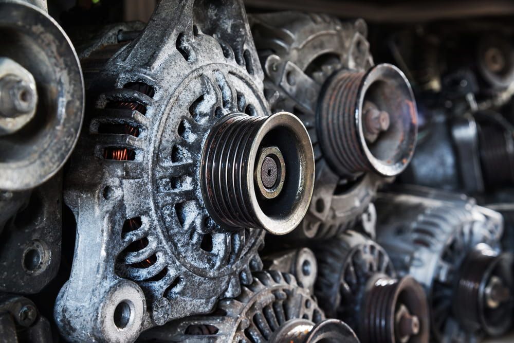 A Stack of Alternators Are Sitting on Top of Each Other — Bago Auto Dismantlers in Thrumster, NSW