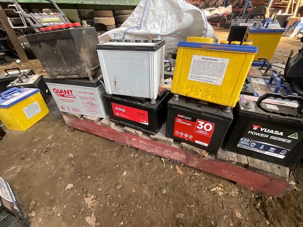 A Bunch Of Batteries Are Stacked On Top Of Each Other On A Pallet — Bago Auto Dismantlers in Lake Cathie, NSW