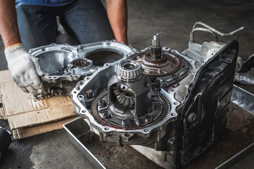 A Man is Working on a Car Engine in a Garage — Bago Auto Dismantlers in Thrumster, NSW