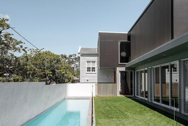 Modern house and pool with empty concrete court, shown in black-and-white above and color below