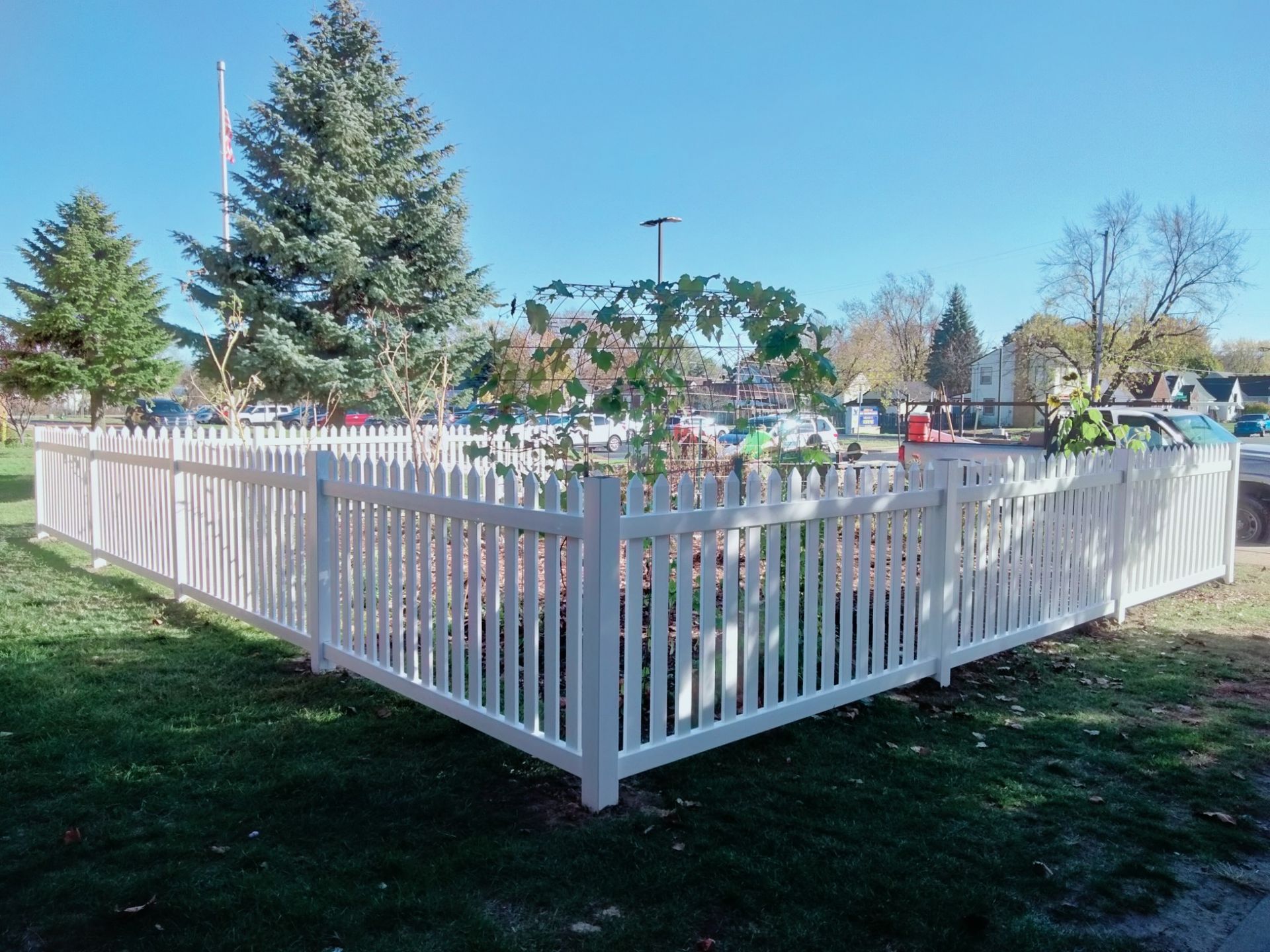 Dog Run Fencing ─ Dog Behind the White Wood Fence  in Grand Rapids, MI