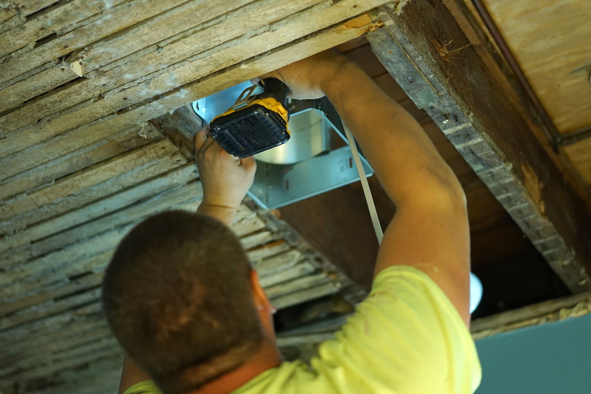 An HVAC contractor installing an air duct camera in a boiler, checking for maintenance and inspection purposes.