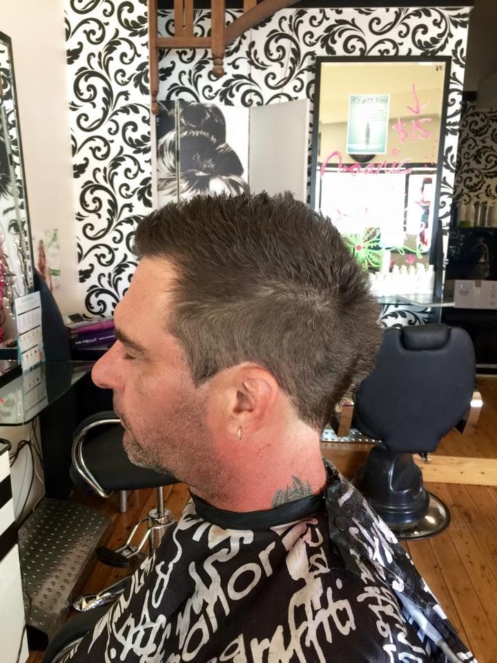 A Man is Getting His Hair Cut in a Salon — Elysian Salon In Wyong, NSW