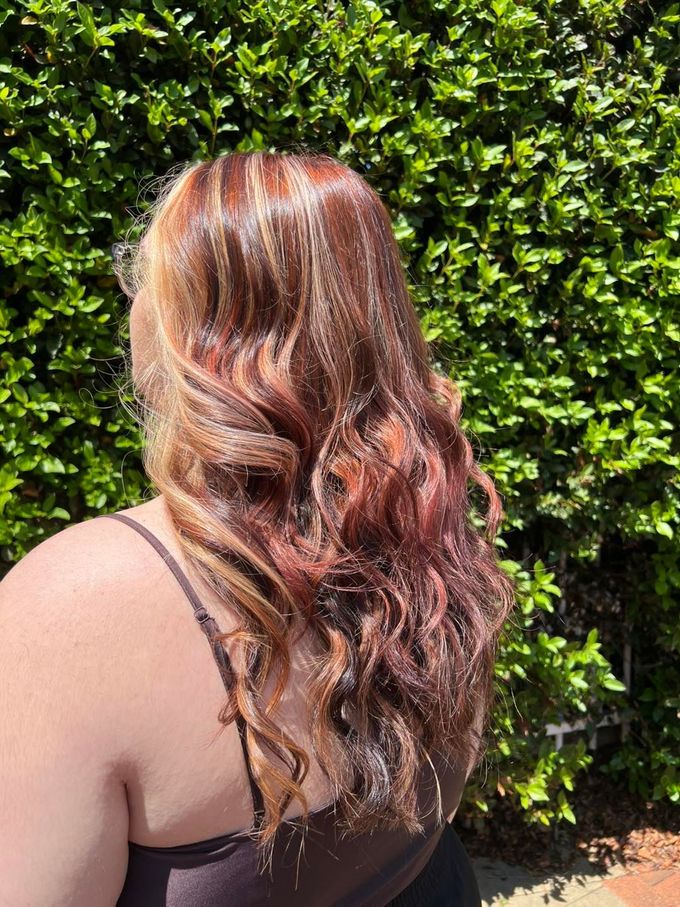A Woman With Long Hair is Wearing a Black Shirt — Elysian Salon In Wyong, NSW