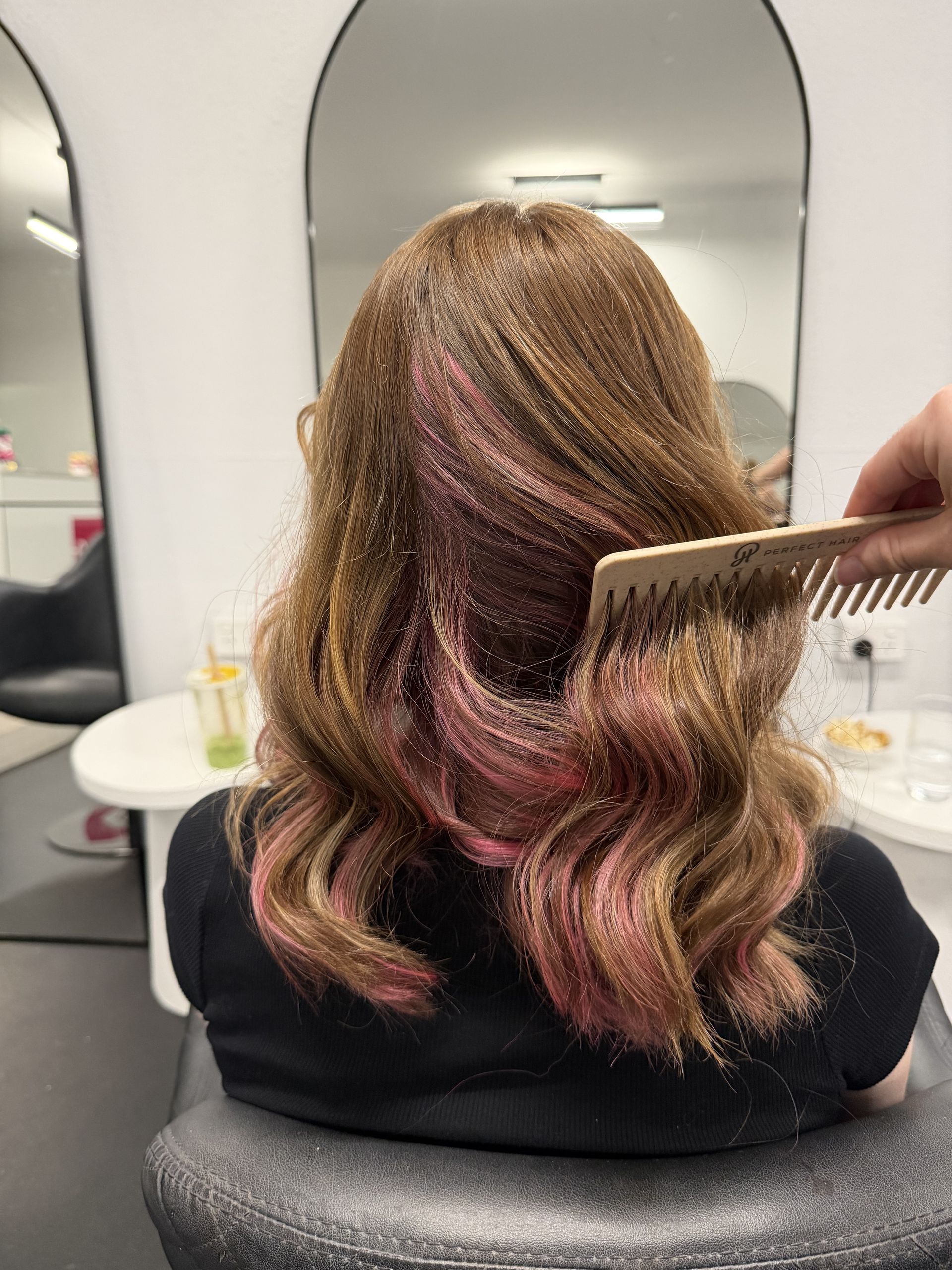 A Woman With Long Hair is Sitting in a Chair in Front of a Mirror — Choo Choo Hair and Beauty In Wyong, NSW A Woman With Long Hair is Sitting in a Chair in Front of a Mirror — Elysian Salon In Wyong, NSW