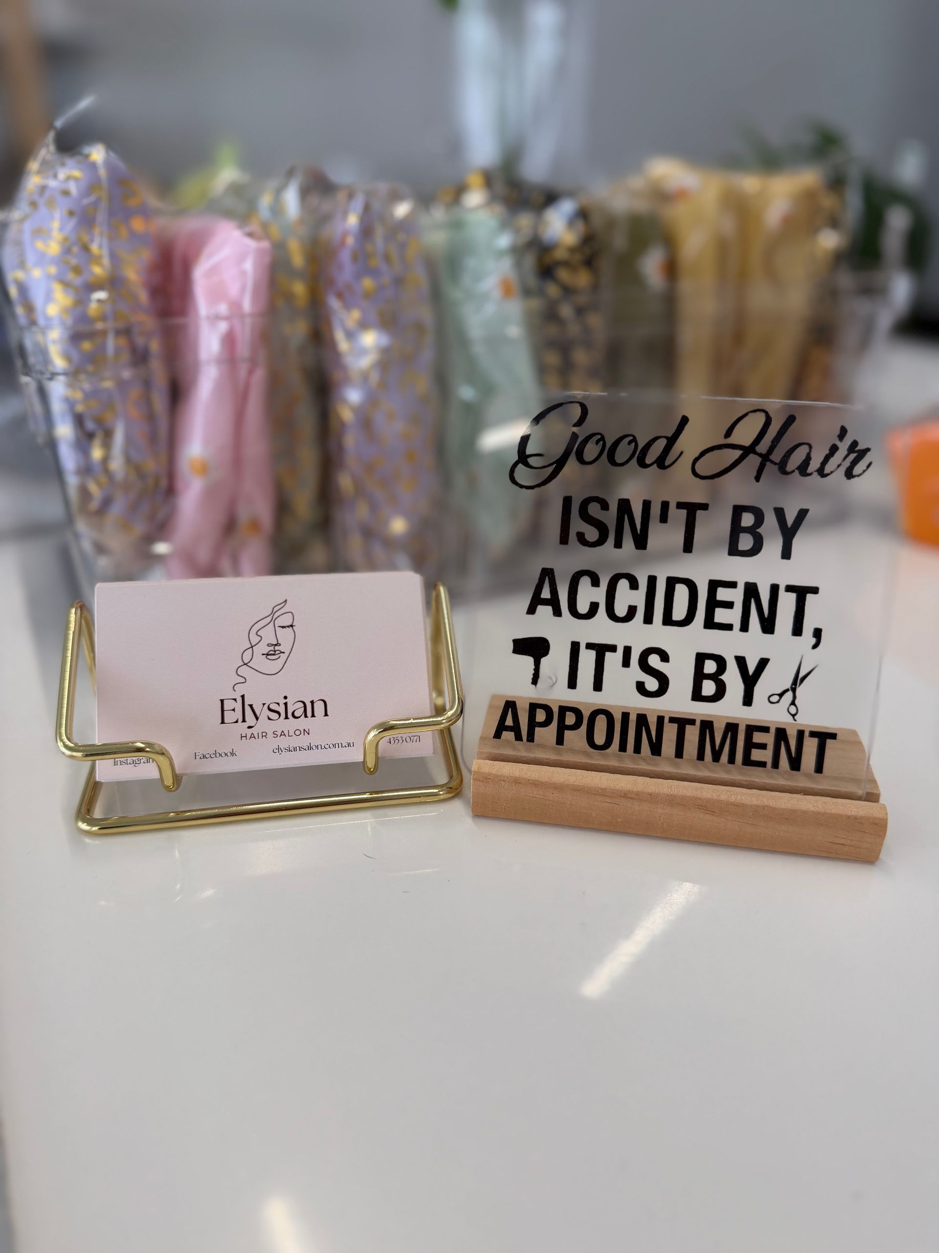 Woman With Long, Wavy, Blonde Hair Styled in a Salon, Seated in a Chair — Elysian Salon In Wyong, NSW