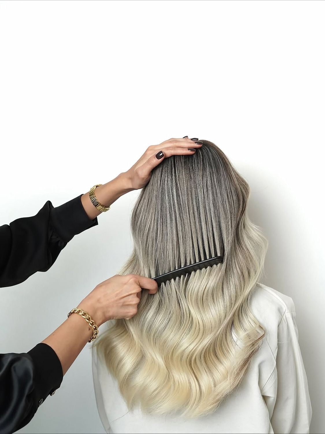 A stylist uses a comb in the clients hair — Elysian Salon In Wyong, NSW