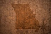Map of Missouri in brown on a textured background with a compass rose.