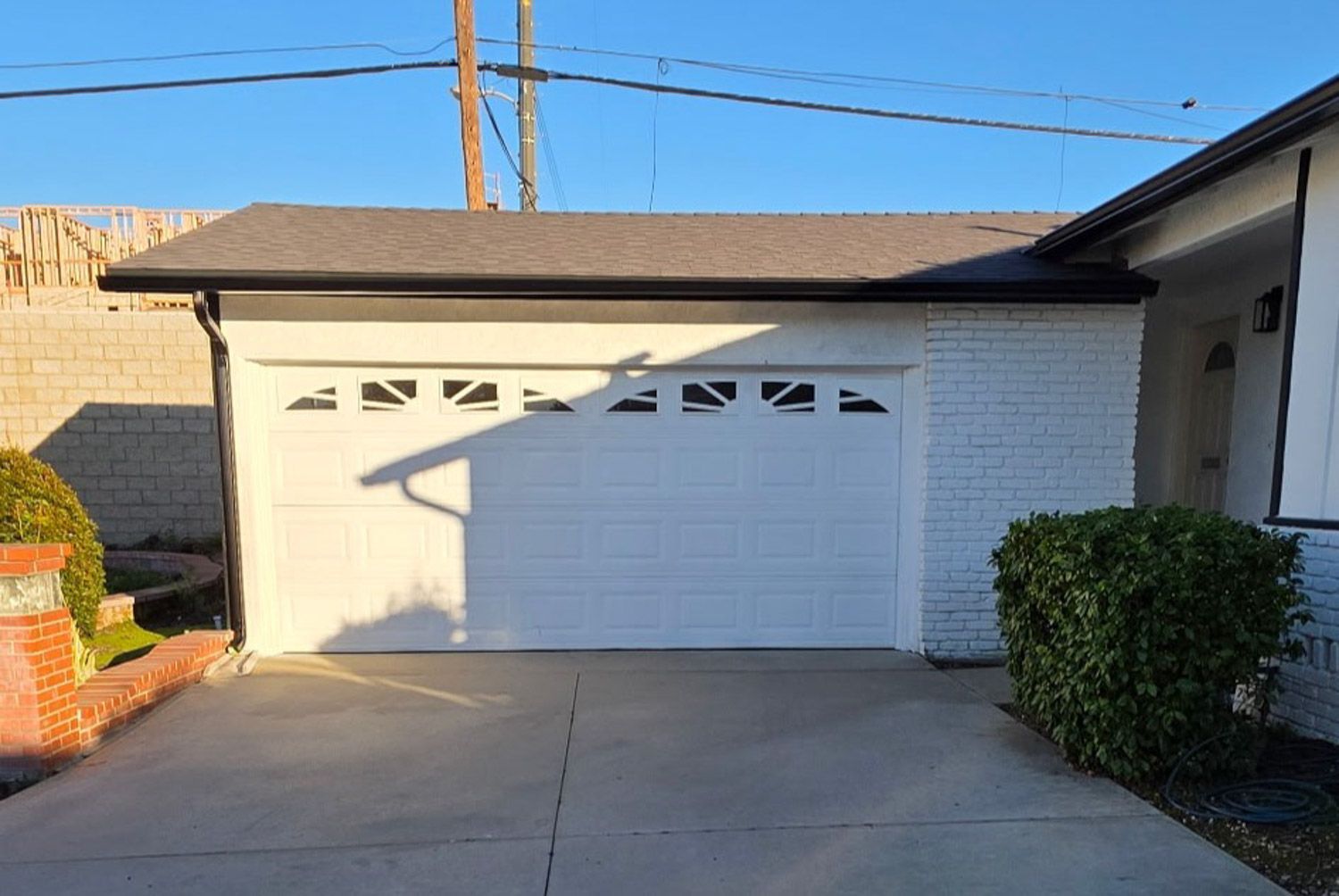 Exterior of a Reno home with new black seamless gutters professionally installed by Gutter Specialis