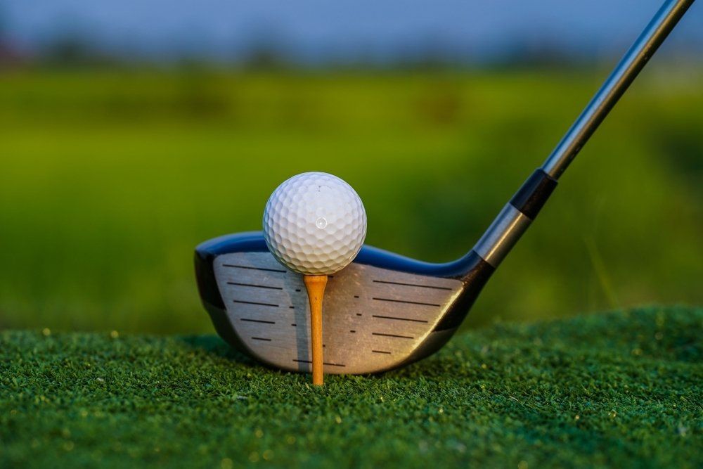 Golf Club and Ball On Green Grass