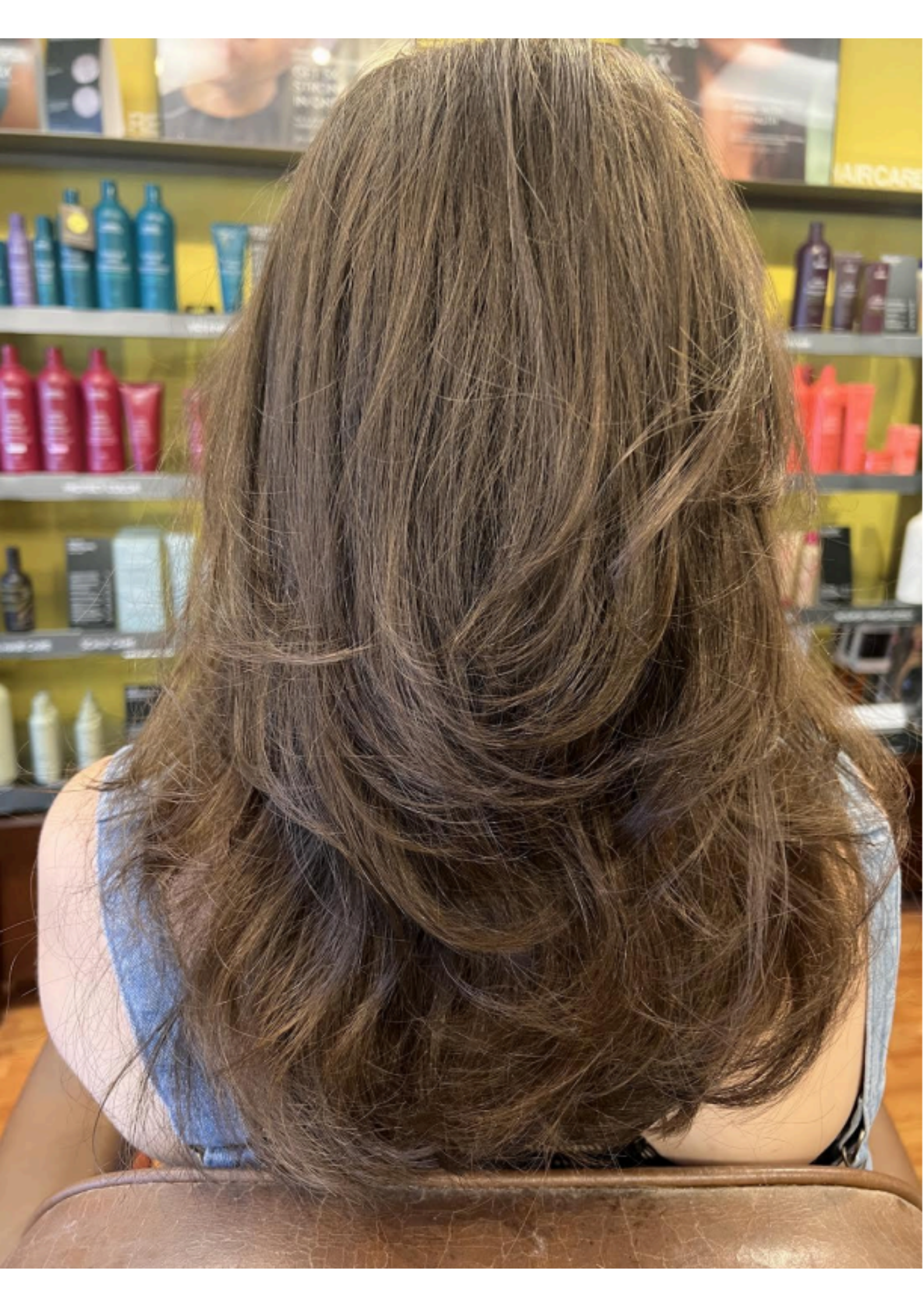 Hairdresser cutting a client’s blonde hair in a salon