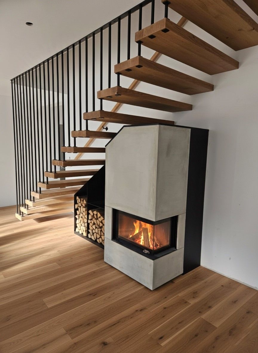 Moderne Treppe mit schwarzem Geländer und eingebautem Eckkamin in einem minimalistischen Raum