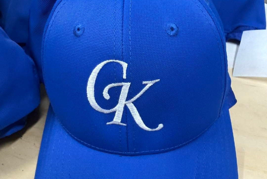 Blue baseball cap with white CK monogram logo on the front