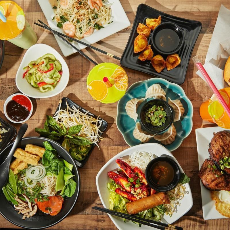 Overhead view of a table filled with assorted colorful dishes and drinks at a meal spread