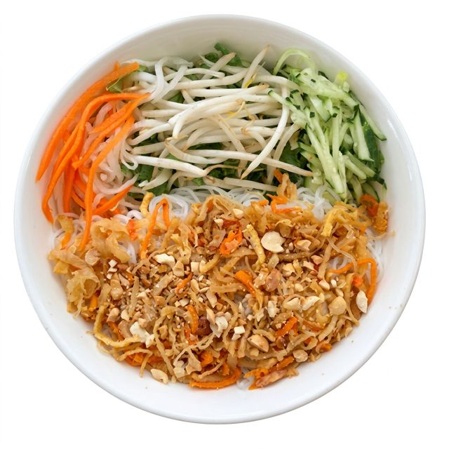 Bowl of shredded vegetables and chopped peanuts arranged in sections, like a fresh salad or noodle bowl