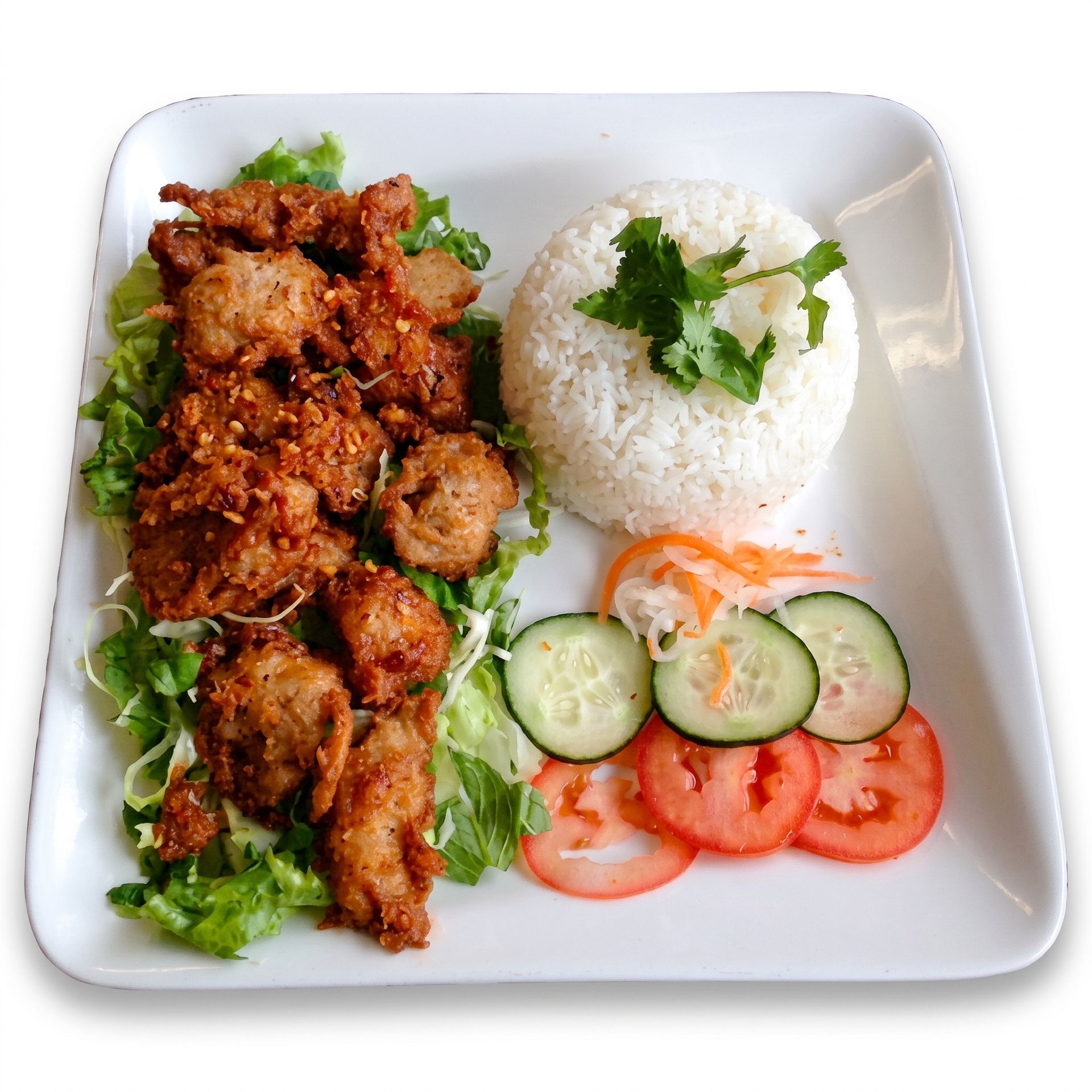 Plated rice with grilled meat, cucumber and tomato slices, garnished with cilantro and lettuce