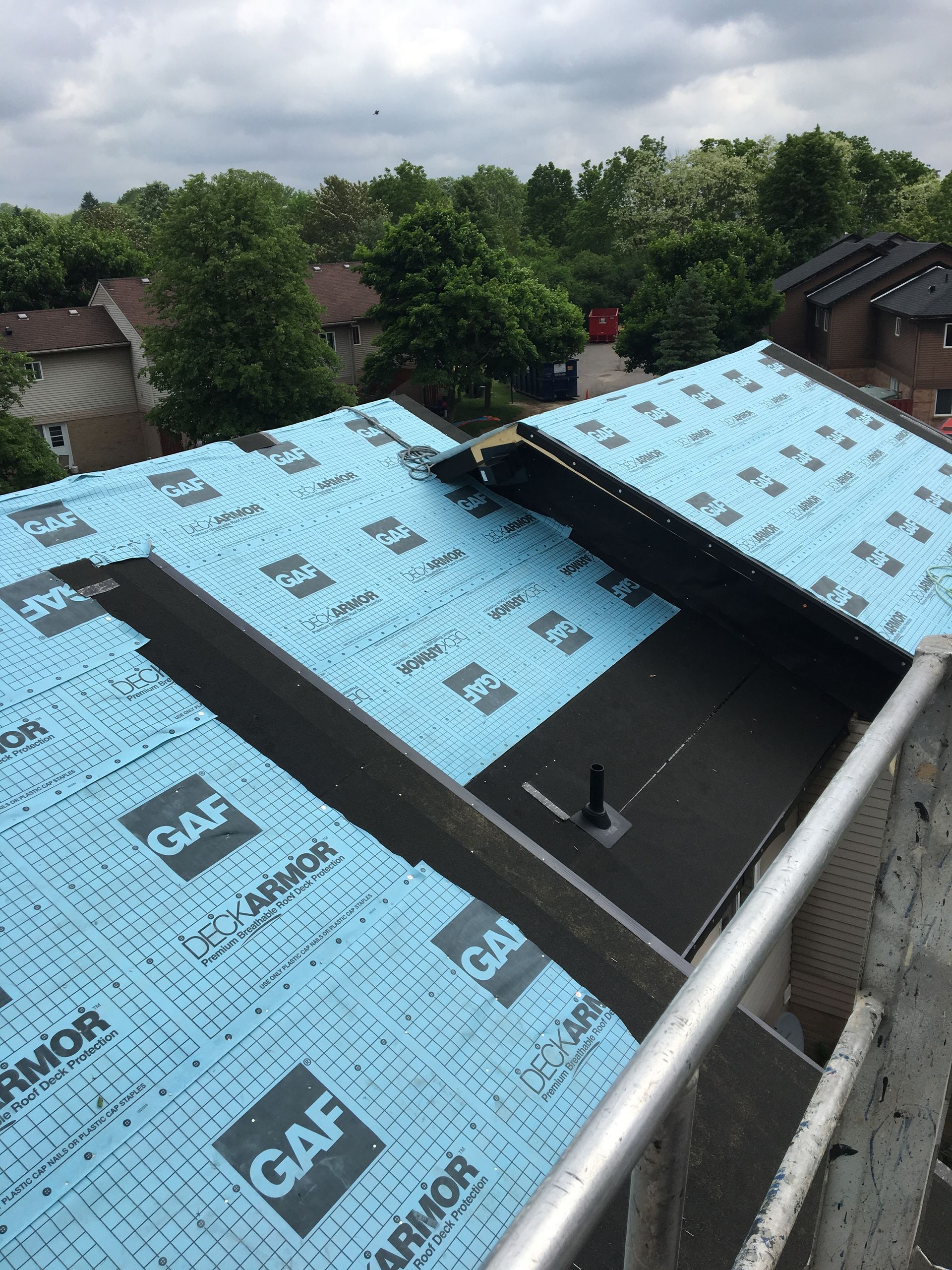 A roof with a blue roofing material that says gaf on it