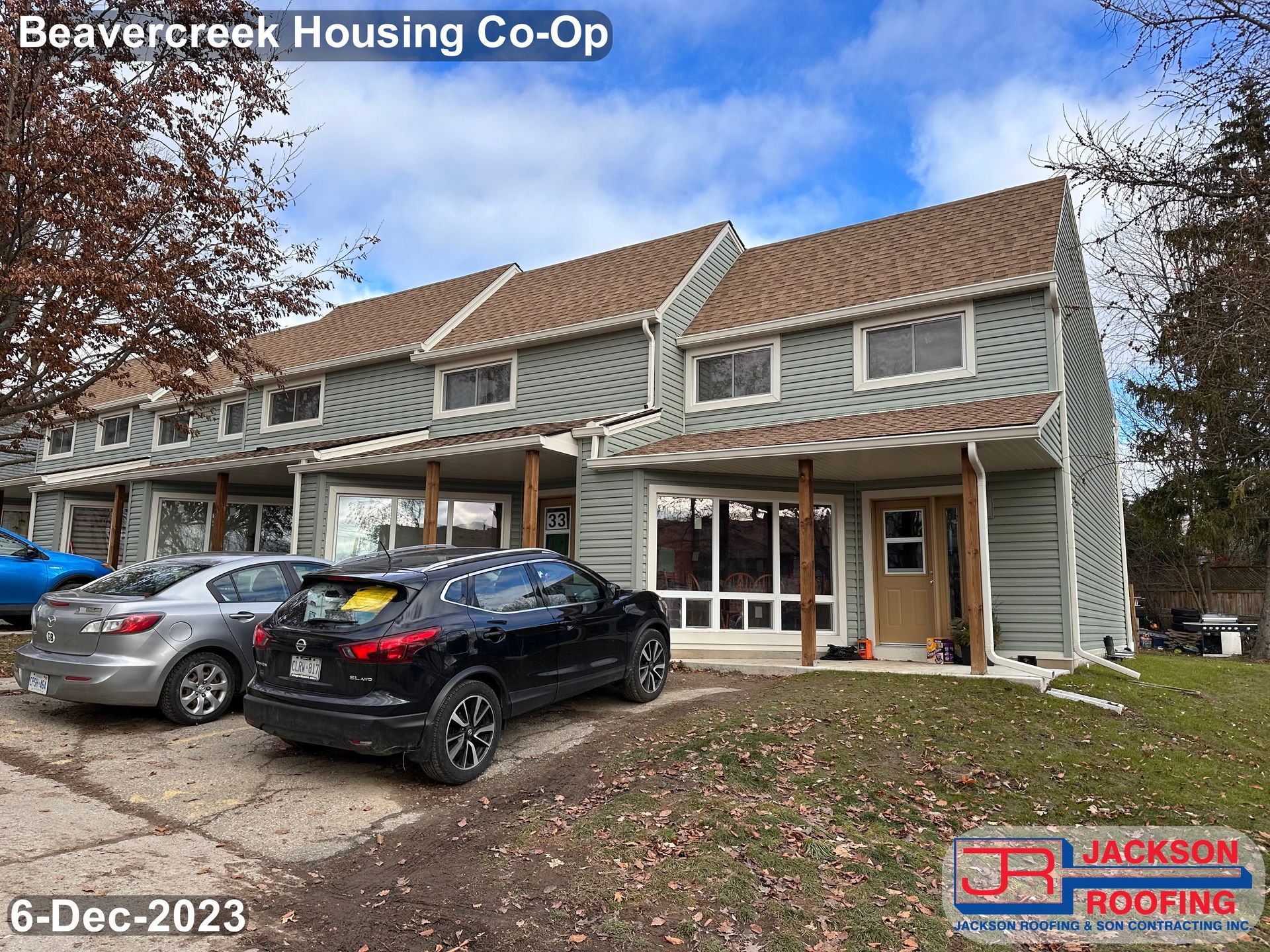 A picture of a beavercreek housing co-op with cars parked in front of it.