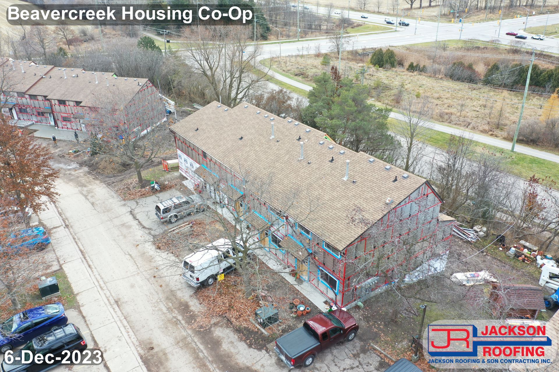 An aerial view of a building under construction with a truck parked in front of it.