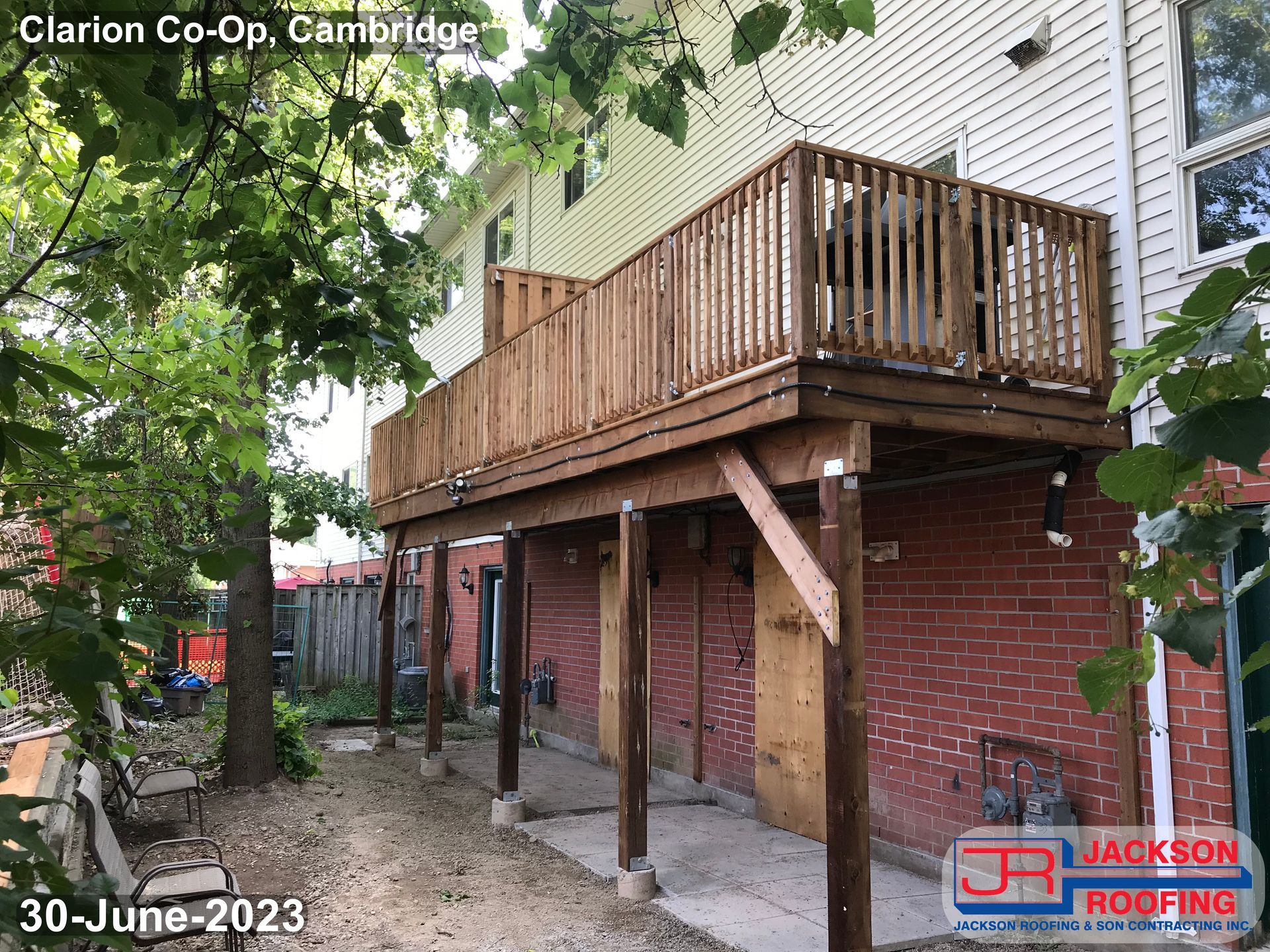 A wooden deck is being built on the side of a house.