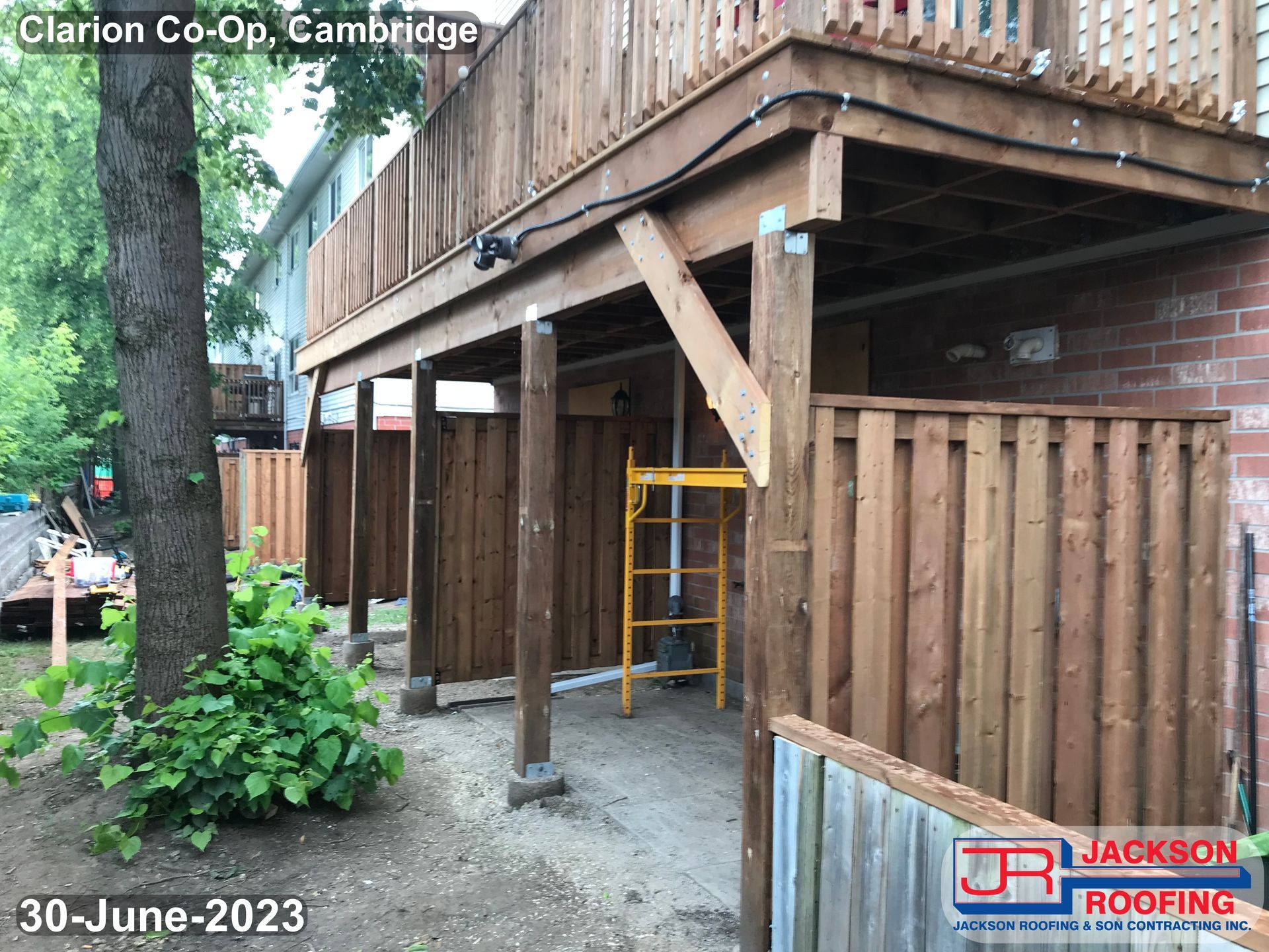 A wooden deck is being built on the side of a house.