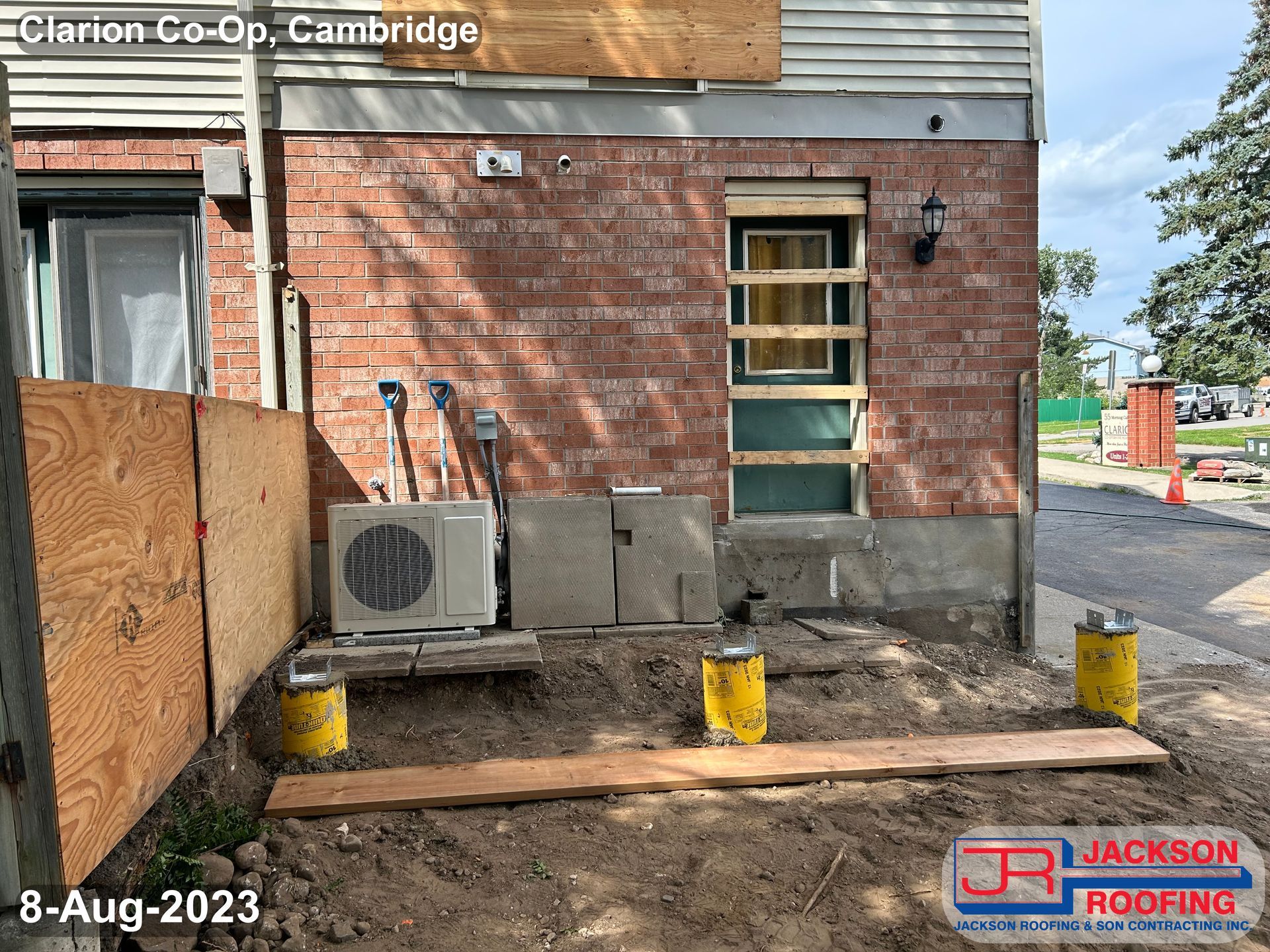 A picture of a brick building being remodeled by jackson roofing