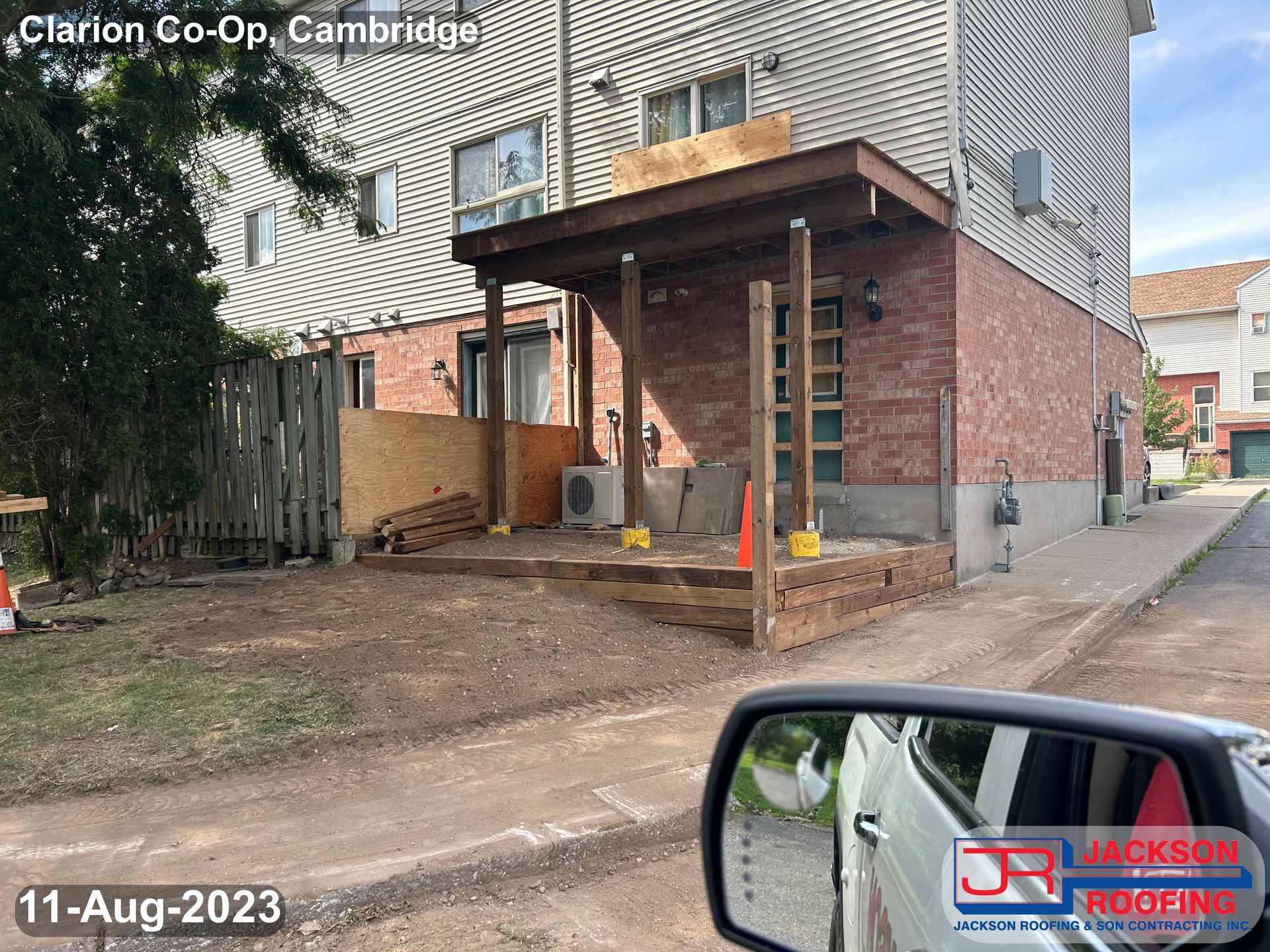 A car is parked in front of a house that is being remodeled.