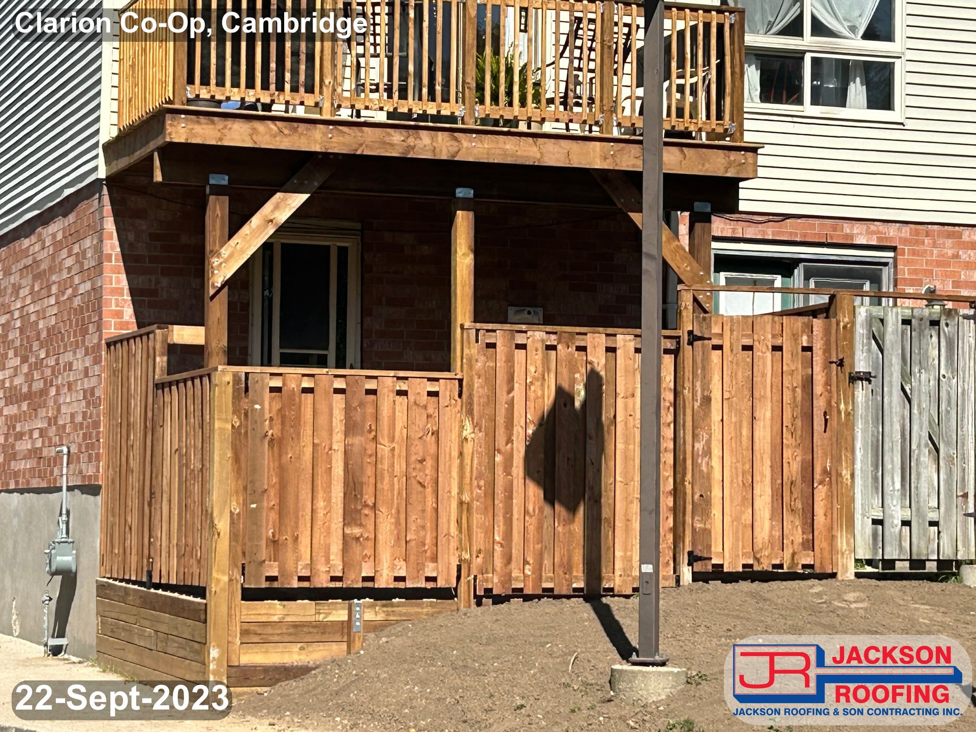 A wooden deck is being built on the side of a house.