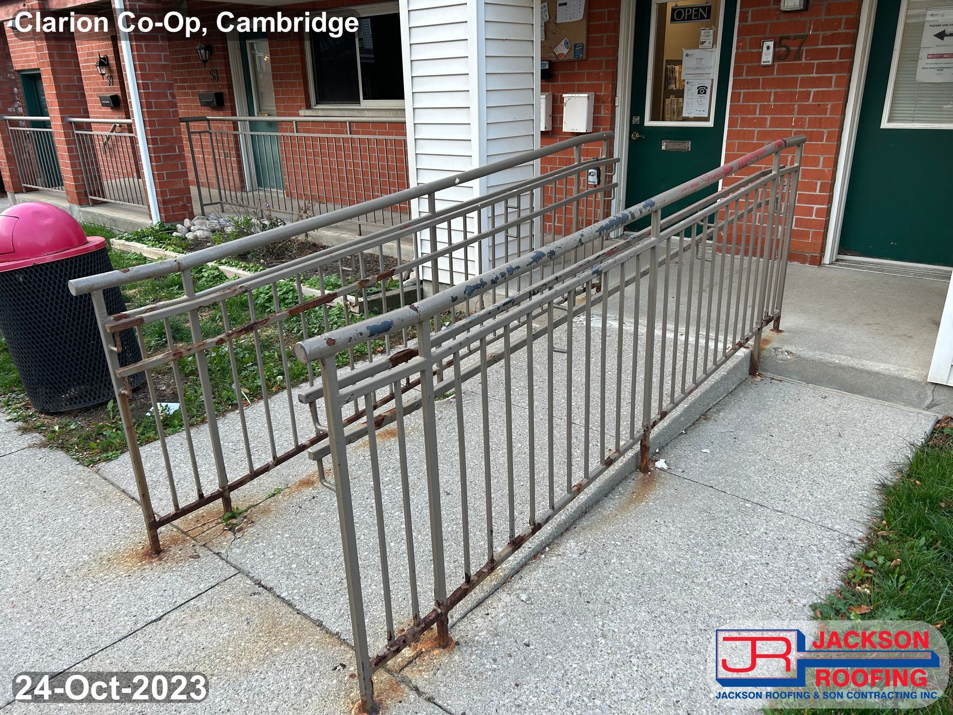 A handicap ramp is sitting on the sidewalk in front of a building.