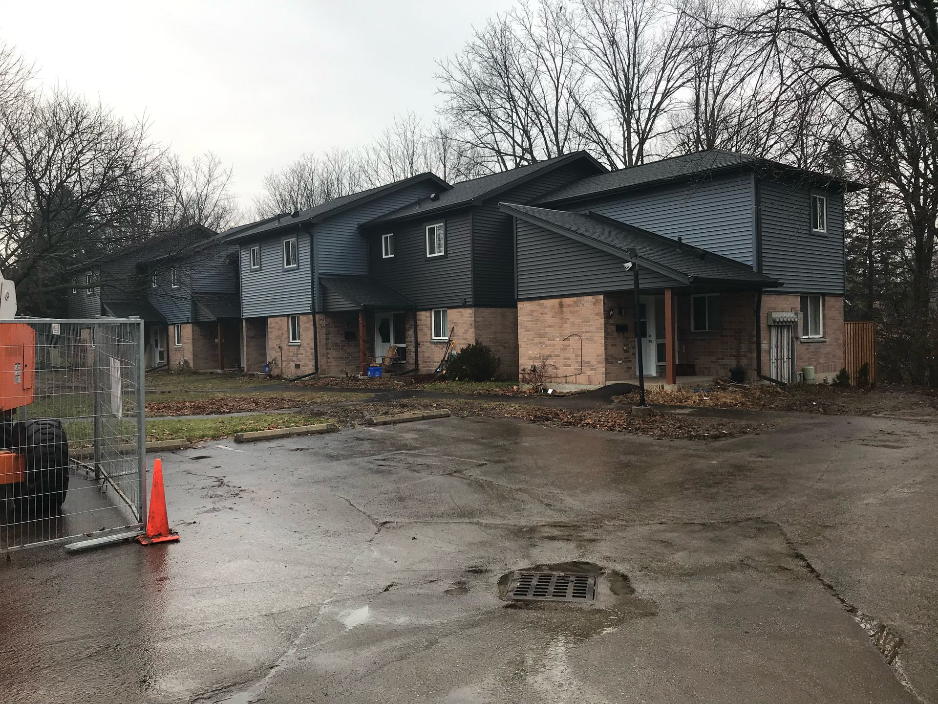 A row of houses are sitting next to each other on a rainy day.
