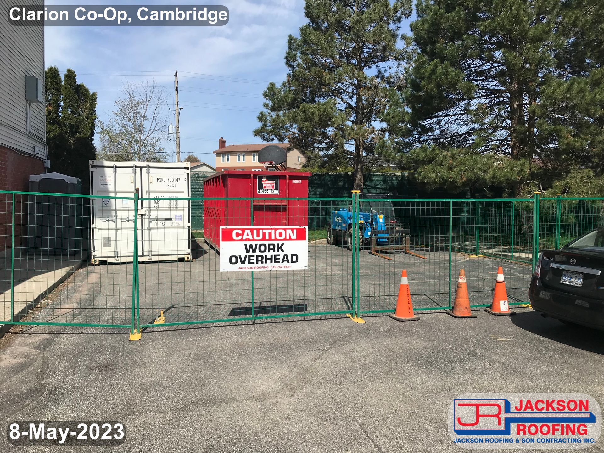 A fence with a sign that says caution work overhead