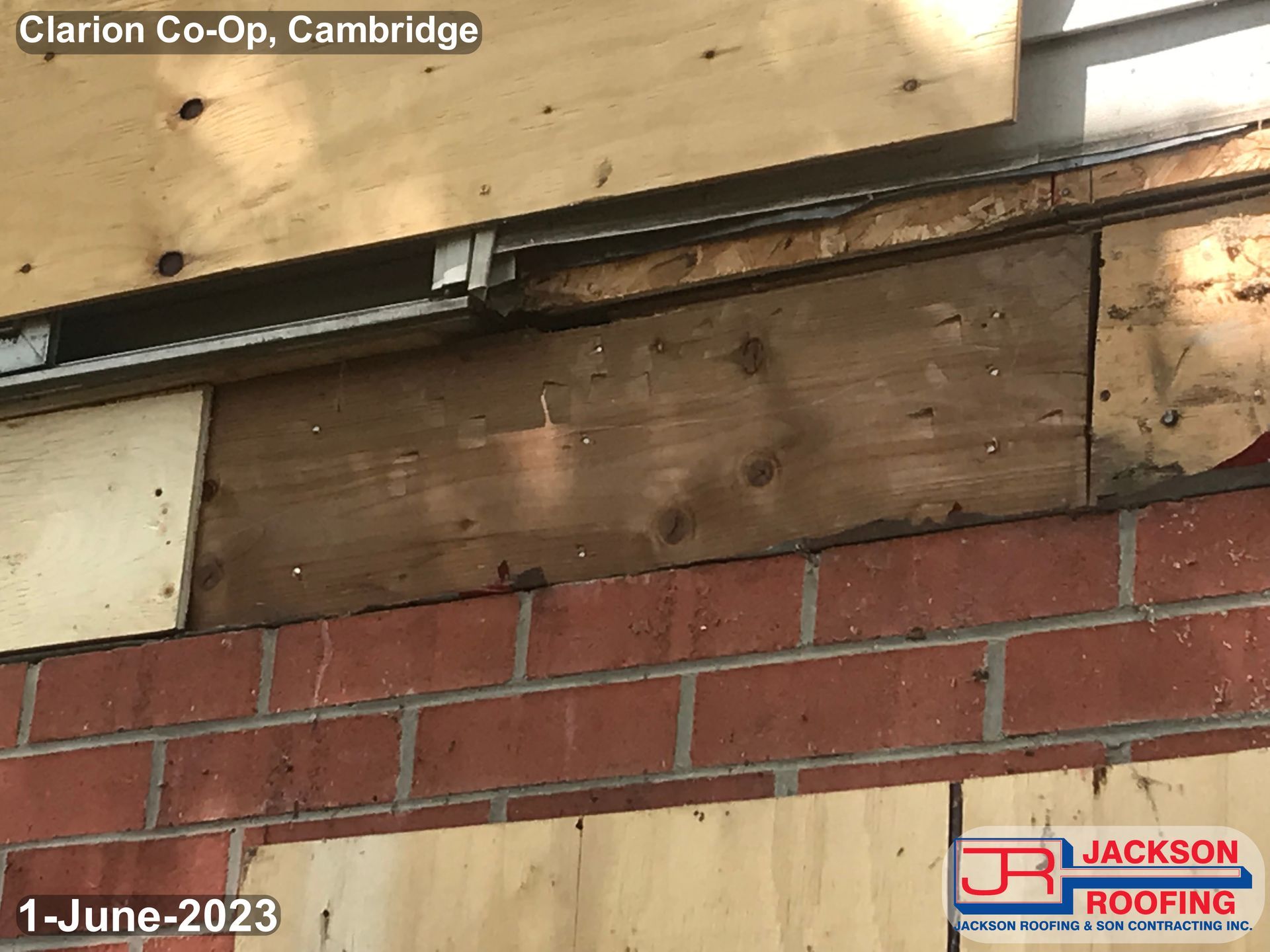 A brick wall with a piece of wood on it.